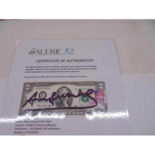 1140 - An Andy Warhol signed two dollar bill in perspex frame with certificate of authenticity.