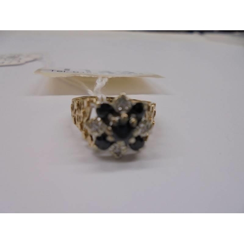 1143 - A 9ct gold diamond and sapphire ring with textured shoulders, dated London 1975, size M half, 4 gram... 