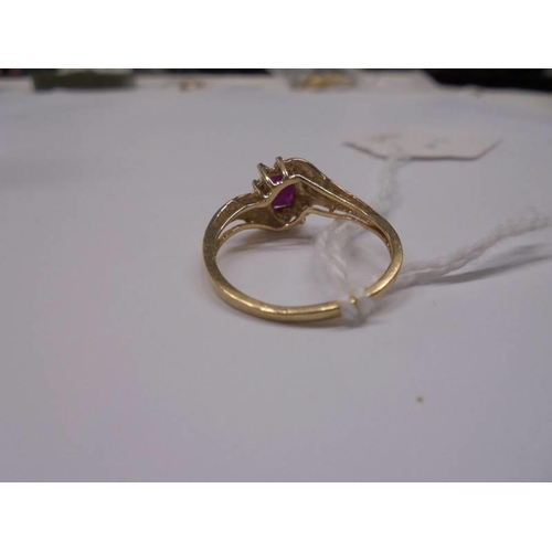 1149 - A ruby and diamond ring in a twist design stamped 10ct, size R, 2,4 grams.