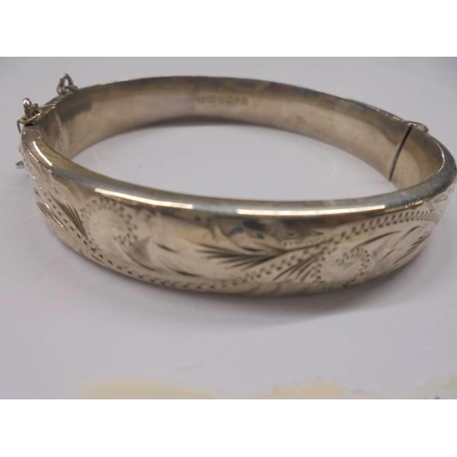 1159 - A vintage style silver engraved bangle, hall marked Birmingham 1979.