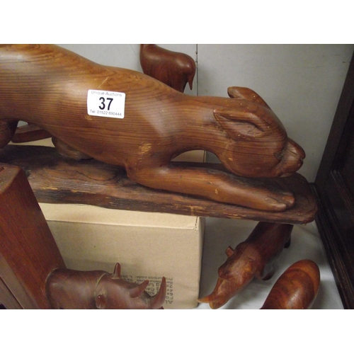 37 - A large carved Mountain Lion length 70cm, height 20cm by Reginald Arthur Tucker August 1975 and good... 