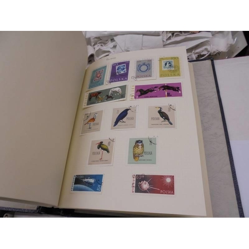 1173 - An album of European stamps and two part albums of world stamps.