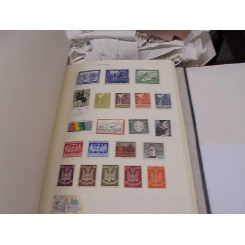 1173 - An album of European stamps and two part albums of world stamps.