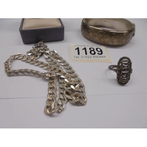 1189 - A silver bangle, silver chain and two silver rings, 47 grams.