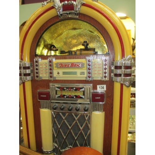 136 - A large jukebox with radio, tape and cd, cd does not work, also a smaller jukebox radio and 2 boxed ... 