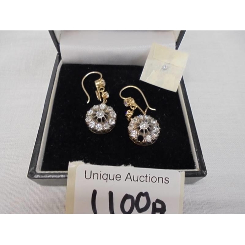 1100A - A pair of diamond earrings, (one stone needs refixing) total weight 5.95 grams.