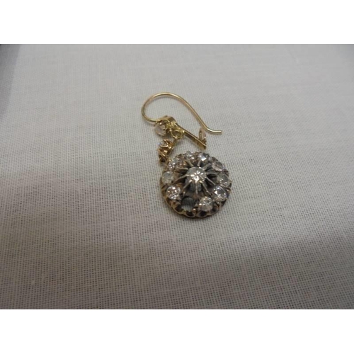 1100A - A pair of diamond earrings, (one stone needs refixing) total weight 5.95 grams.