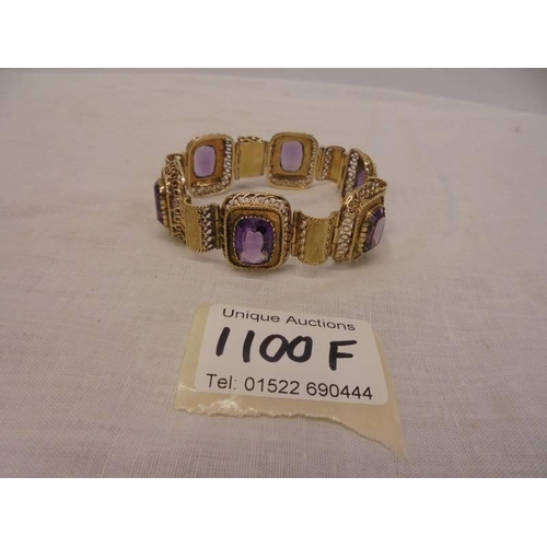 1100F - An 14ct gold (585) bracelet set six large amethyst stones, total weight 42.39 grams.