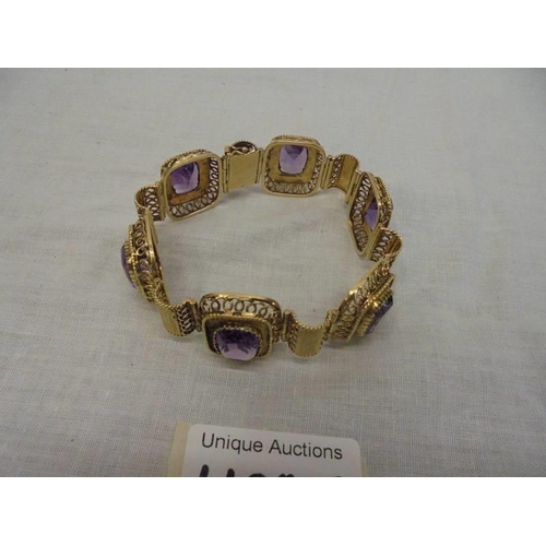 1100F - An 14ct gold (585) bracelet set six large amethyst stones, total weight 42.39 grams.