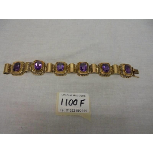 1100F - An 14ct gold (585) bracelet set six large amethyst stones, total weight 42.39 grams.