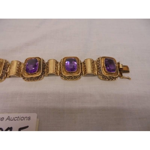 1100F - An 14ct gold (585) bracelet set six large amethyst stones, total weight 42.39 grams.