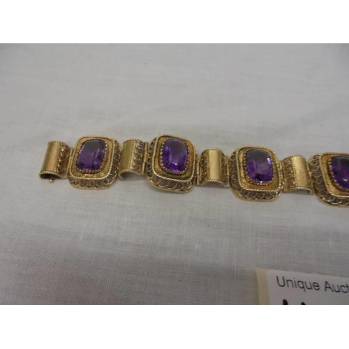 1100F - An 14ct gold (585) bracelet set six large amethyst stones, total weight 42.39 grams.