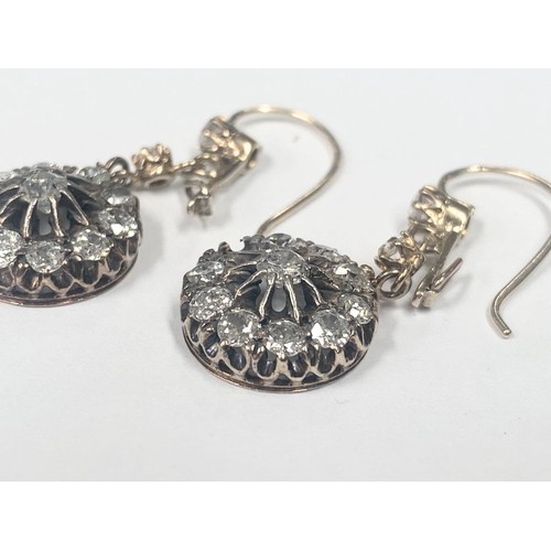 1100A - A pair of diamond earrings, (one stone needs refixing) total weight 5.95 grams.