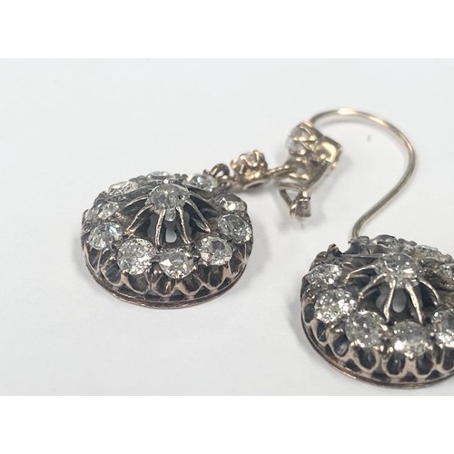 1100A - A pair of diamond earrings, (one stone needs refixing) total weight 5.95 grams.