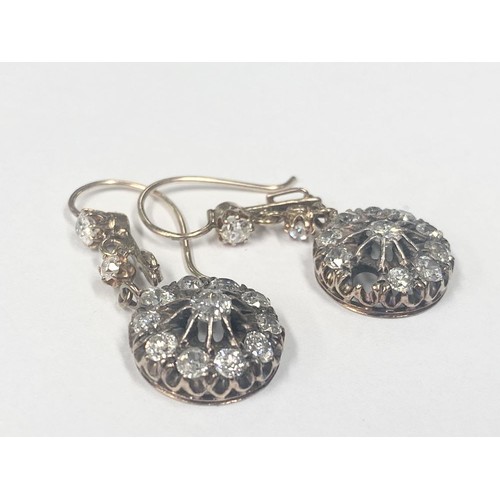 1100A - A pair of diamond earrings, (one stone needs refixing) total weight 5.95 grams.