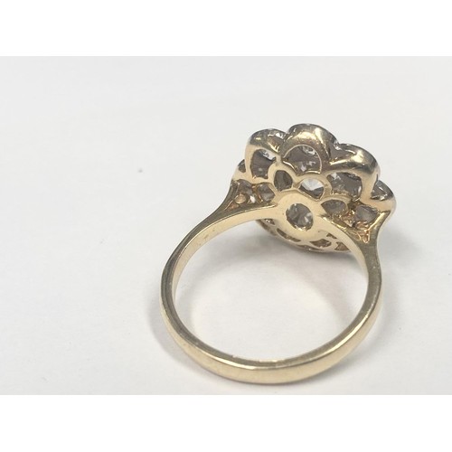 1100C - An 18ct round cluster head ring set with an early round brilliant cut diamond surrounded by 8 old cu... 