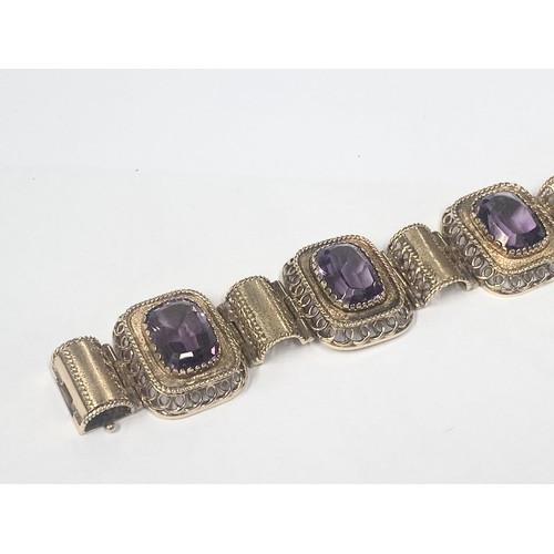 1100F - An 14ct gold (585) bracelet set six large amethyst stones, total weight 42.39 grams.