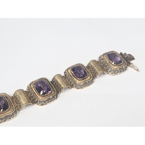 1100F - An 14ct gold (585) bracelet set six large amethyst stones, total weight 42.39 grams.