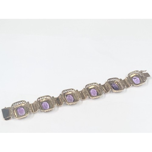 1100F - An 14ct gold (585) bracelet set six large amethyst stones, total weight 42.39 grams.