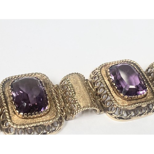 1100F - An 14ct gold (585) bracelet set six large amethyst stones, total weight 42.39 grams.