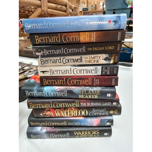 294 - A quantity of Bernard Cornwell military novels (hard & paperbacks) & a quantity of true story war pa... 