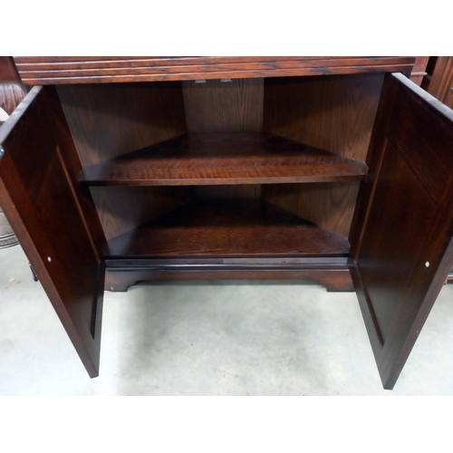 308 - A dark oak corner cupboard with leaded glass doors COLLECT ONLY