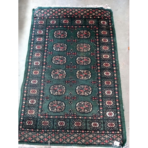 333 - An old green wool rug, 80cm x 135cm COLLECT ONLY