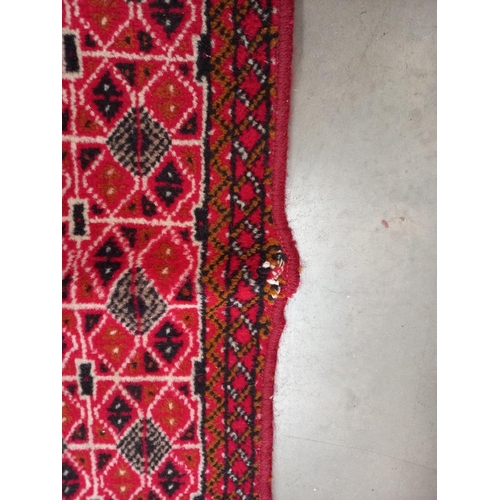 334 - An old red wool rug, 61cm x 140cm COLLECT ONLY