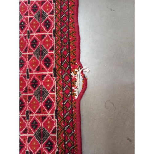 334 - An old red wool rug, 61cm x 140cm COLLECT ONLY