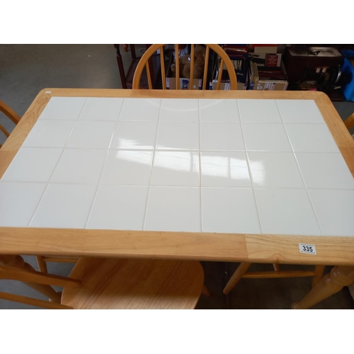 335 - A white tile top table & 4 chairs COLLECT ONLY