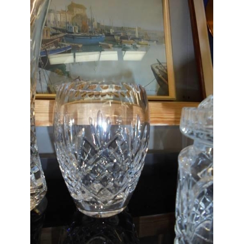 16 - Two cut glass vases, a cut glass biscuit jar and a moulded glass sugar bowl with lid, COLLECT ONLY.