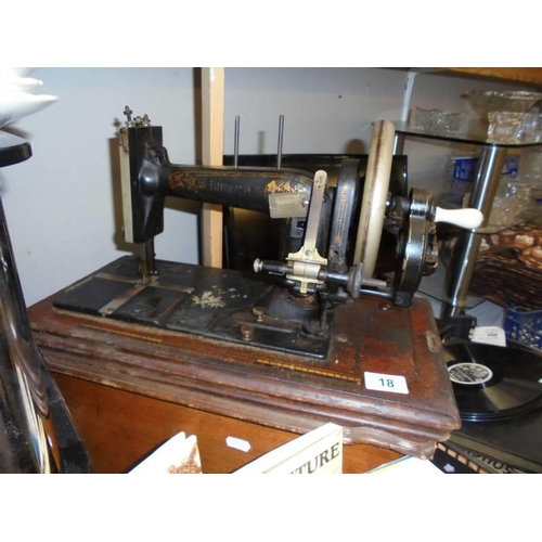 18 - A vintage wood cased sewing machine. COLLECT ONLY.