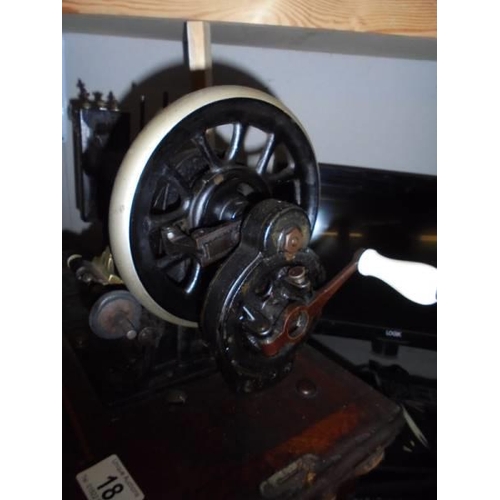 18 - A vintage wood cased sewing machine. COLLECT ONLY.