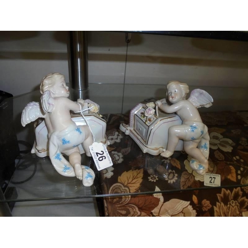 26 - A pair of porcelain cherub wall pockets.