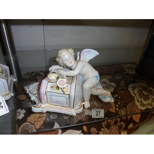 26 - A pair of porcelain cherub wall pockets.