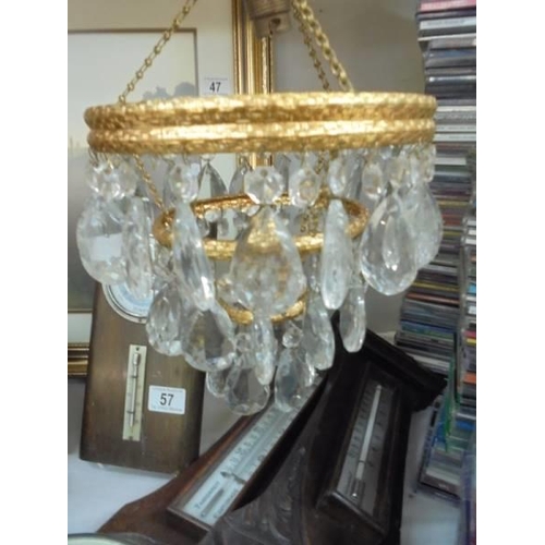 61 - A three tier glass chandelier.