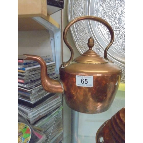 65 - A Victorian copper kettle and a copper washing posher.