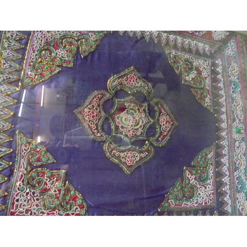 79 - A framed and glazed Asian embroidered panel. COLLECT ONLY.