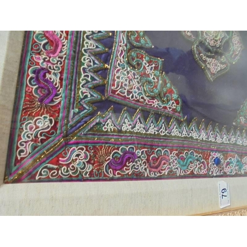 79 - A framed and glazed Asian embroidered panel. COLLECT ONLY.