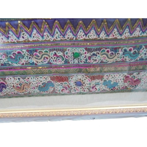 79 - A framed and glazed Asian embroidered panel. COLLECT ONLY.