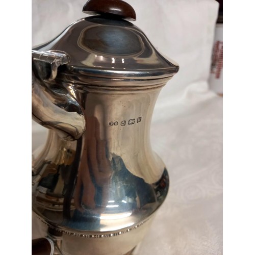 1163 - A silver coffee pot, sugar bowl and milk jug,