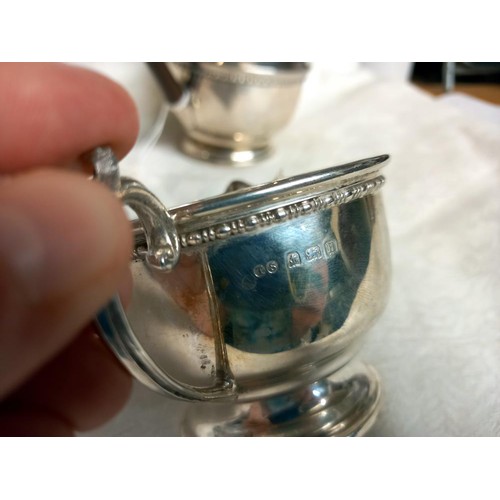 1163 - A silver coffee pot, sugar bowl and milk jug,