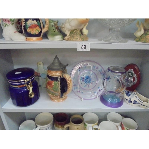 89 - Five shelves of ceramics, glass and three stainless steel pans, COLLECT ONLY.