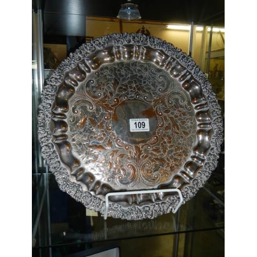 109 - An ornate silver plate on copper tray, (plate worn).