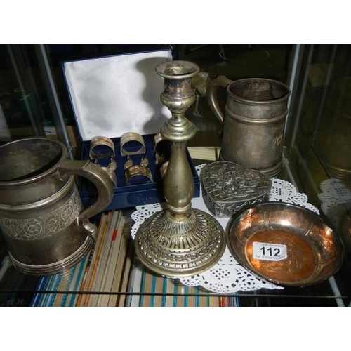 112 - A mixed lot including napkin rings, tankards, candlestick etc.,