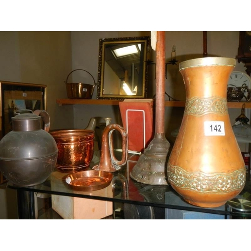 142 - A mixed lot of brass and copper including jug, vase etc.,