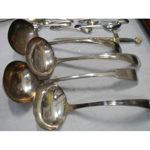 149 - Four silver plate soup ladles and other cutlery.