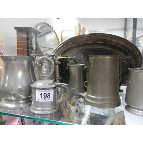 198 - A mixed lot of pewter tankards and other metal ware.