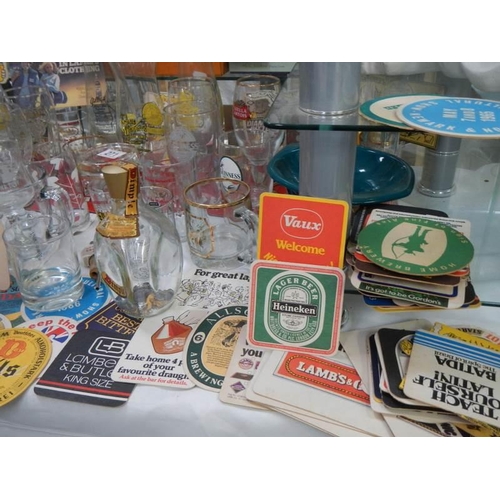 271 - A mixed lot of pub glasses and beer mats,. COLLECT ONLY.