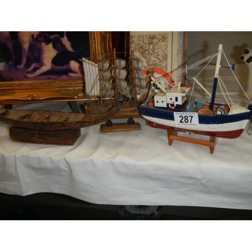 287 - A model fishing boat and a model rowing boat.